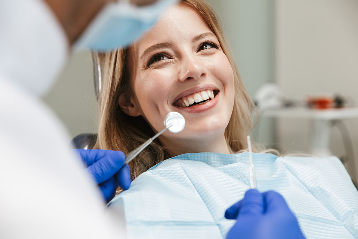 a woman smiling after finally getting Toothache relief