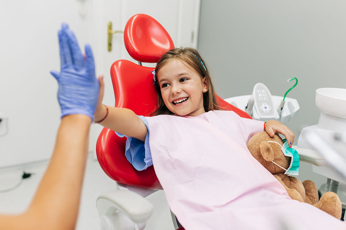 child highfiving dentist best pediatric dentist