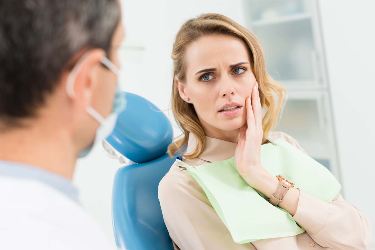 patient in dentist chair wondering Do I Need a Dentist for a Dental Emergency