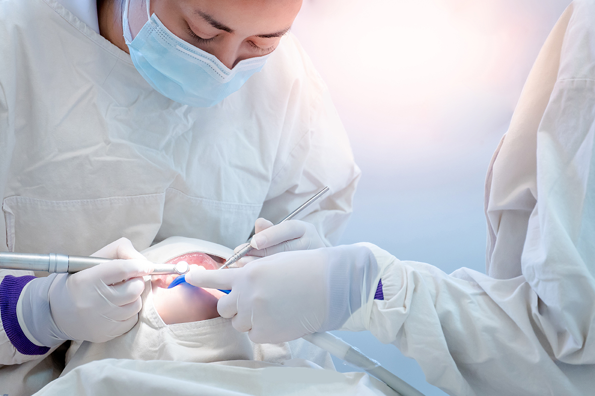 dentists working on patient showing what is a dental emergency