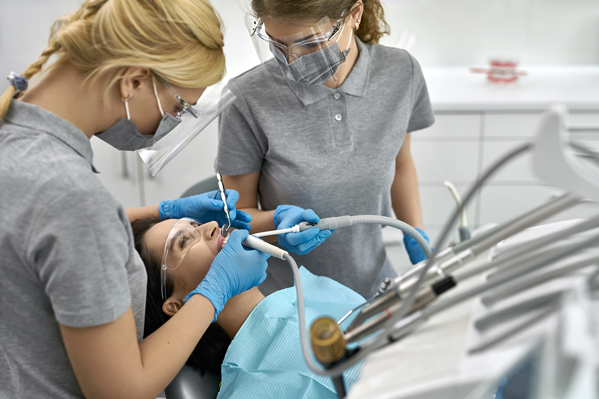 dentist and hygienist performing Dental Health Services