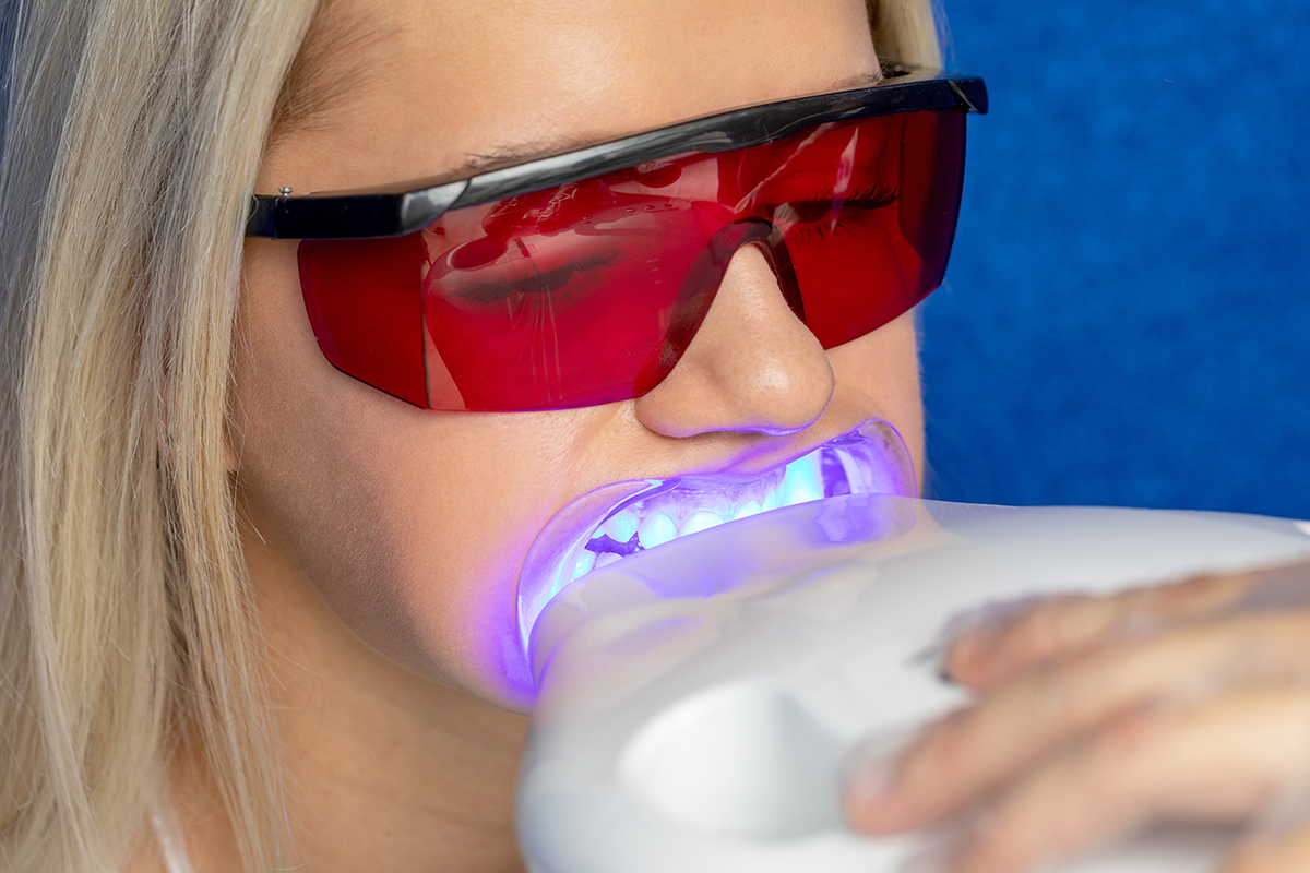 woman getting teeth whitening options performed