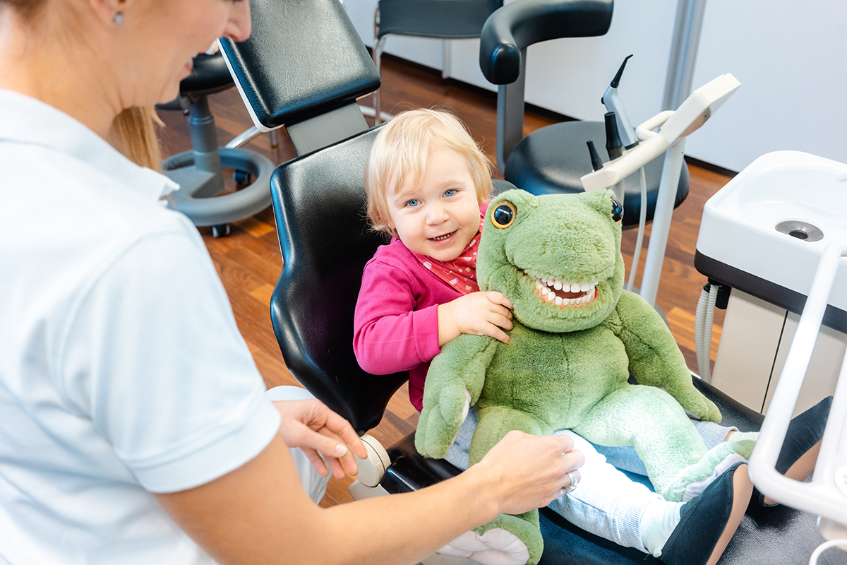 small child in dental chair showing when should a child go to the dentist