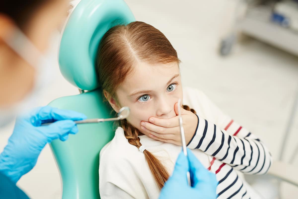 girl has fear of the dentist.