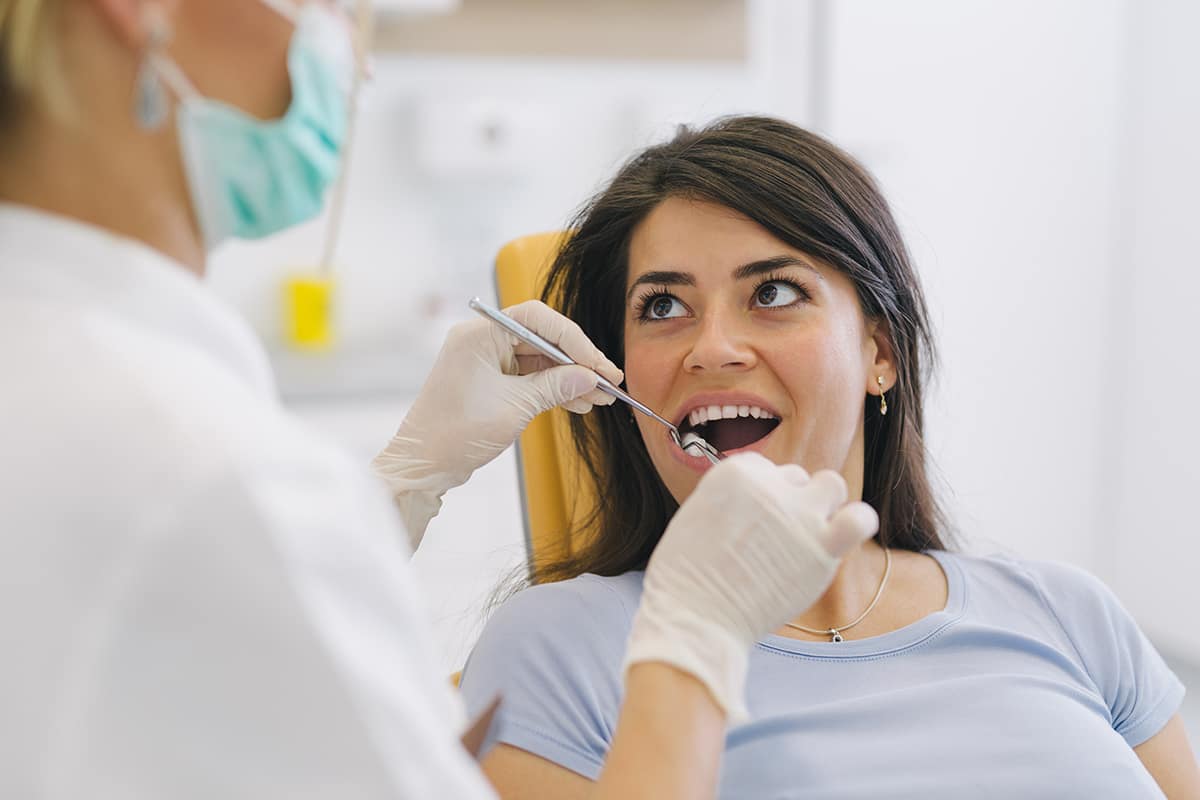 Woman asks dentist how to fix gingivitis.