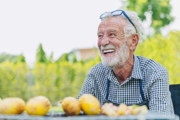 an elderly man smiling brightly 