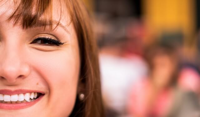 half face of a woman smiling