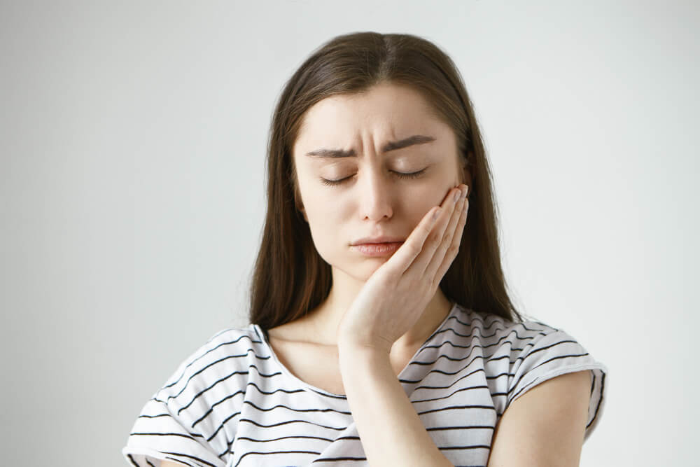 woman in stripes with toothache