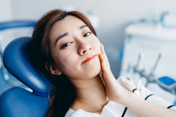 a woman with tooth pain at the dental clinic