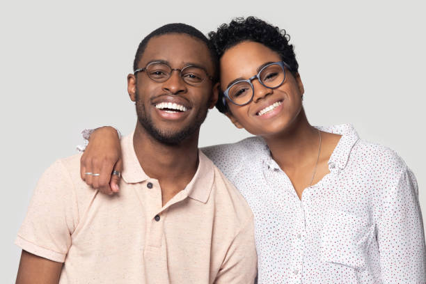 a man and a woman smiling brightly with their perfect teeth
