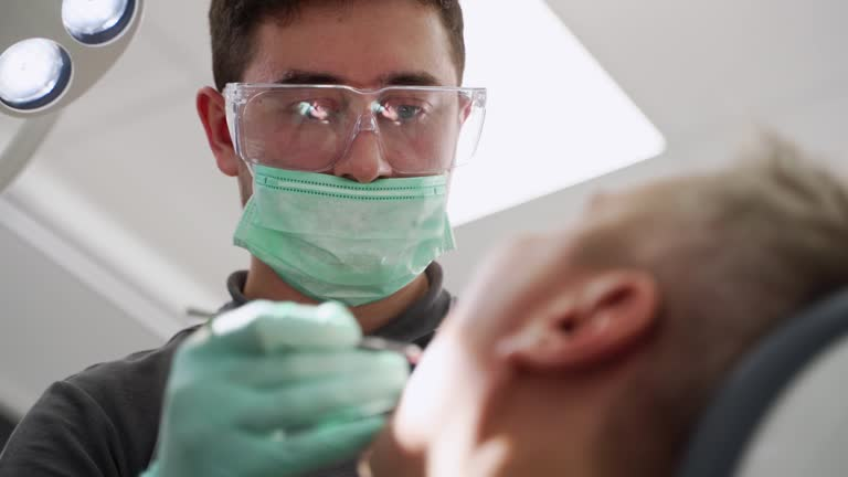 photo of a dentist attending to his patient