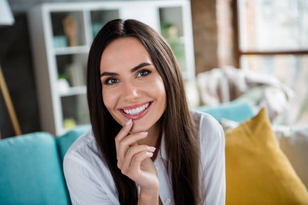 a woman smiling widely with beautiful set of teeth