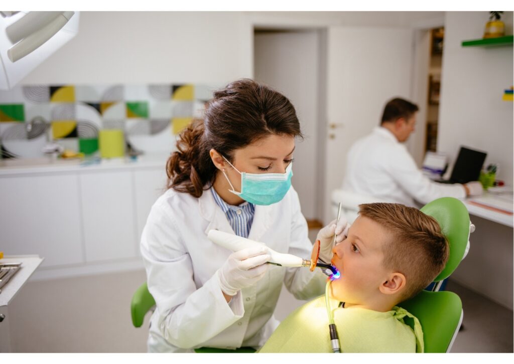 Pediatric dentist applying dental sealants to protect a child’s teeth from cavities and decay