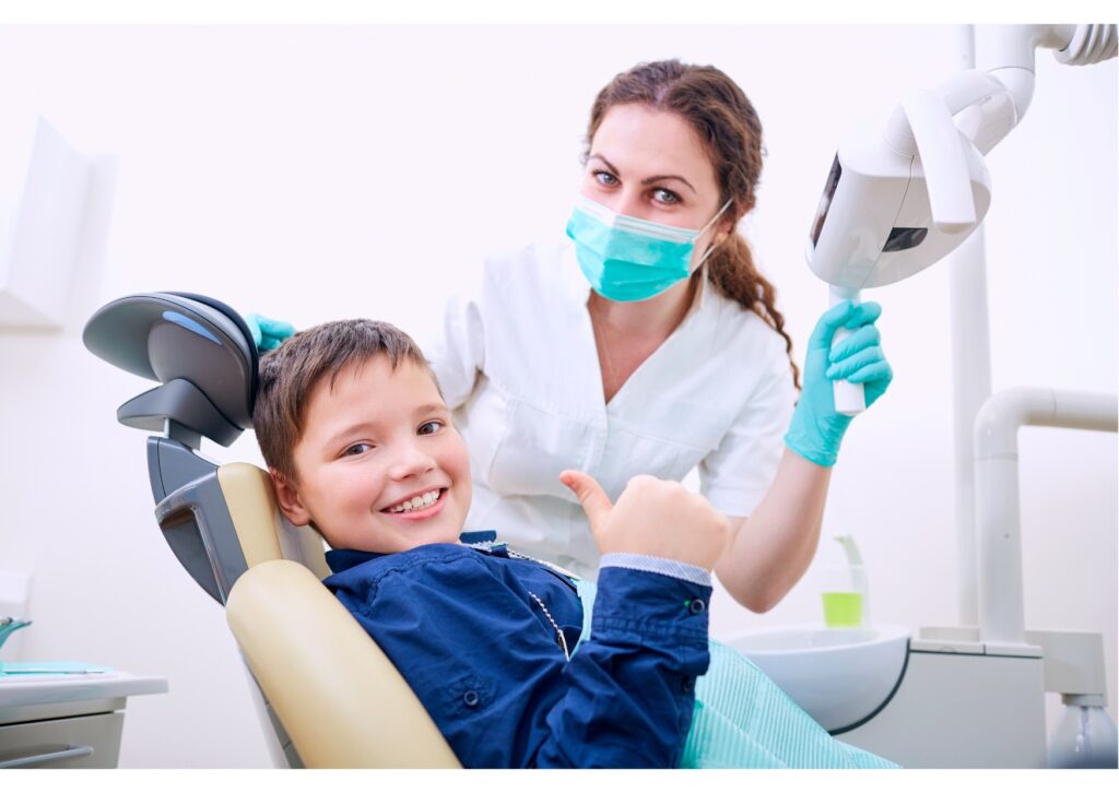 Child smiling during a dental visit for preventive care and dental sealants treatment