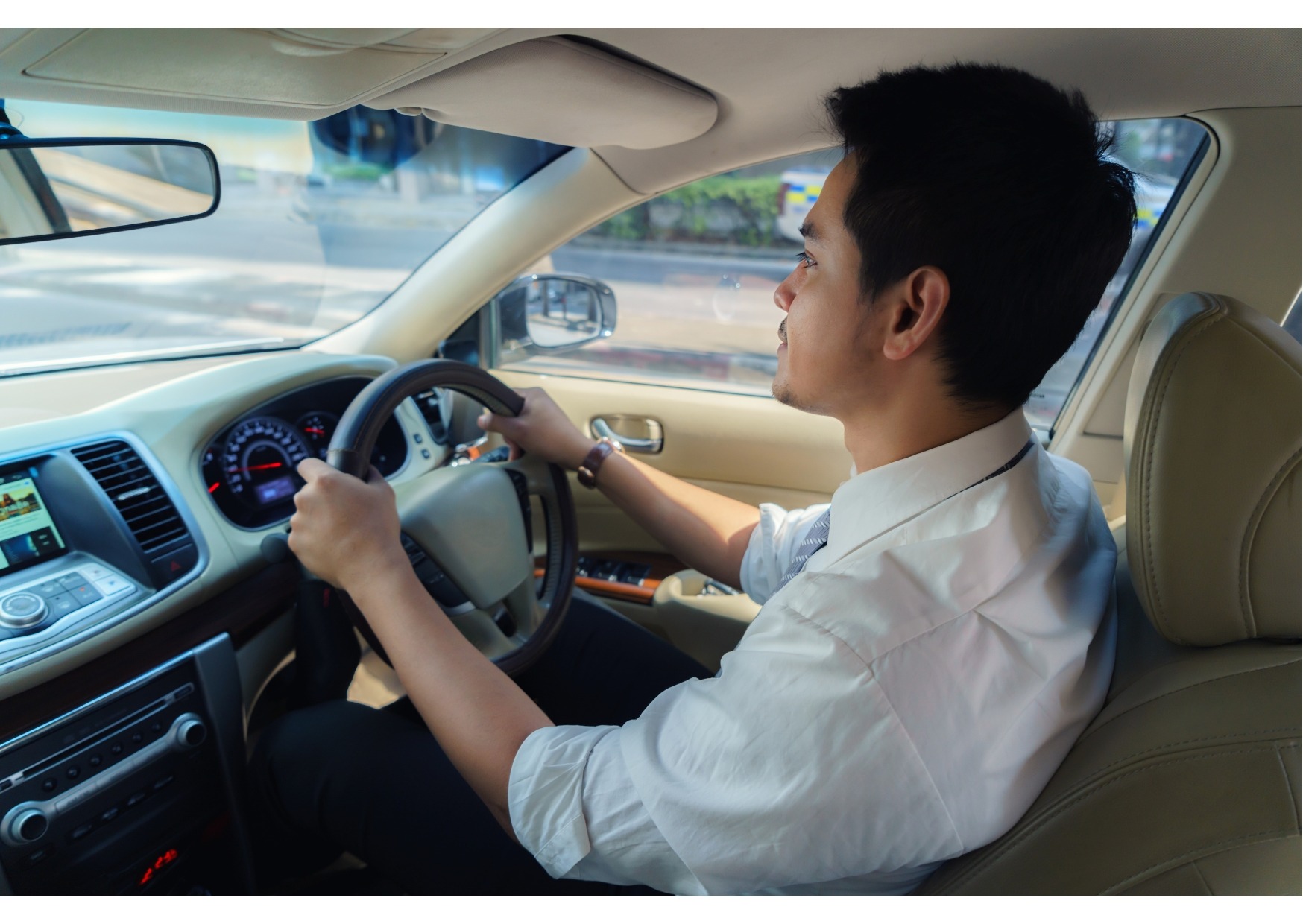 Man driving a car after a routine root canal appointment at the dentist