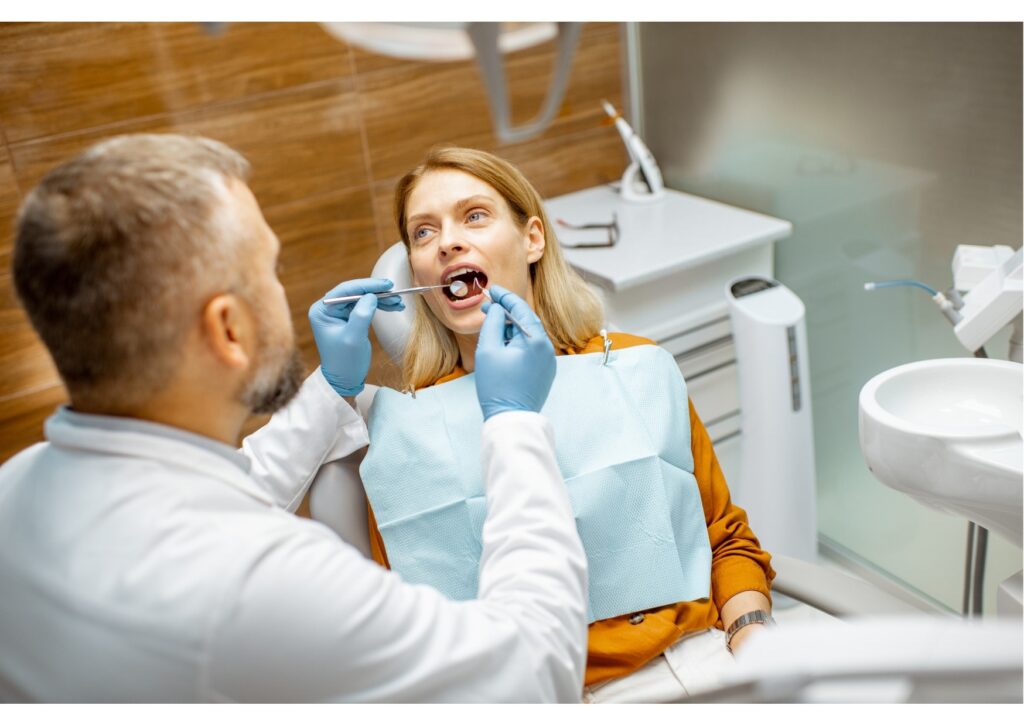 Dentist checking a patient’s dead tooth during a routine oral examination