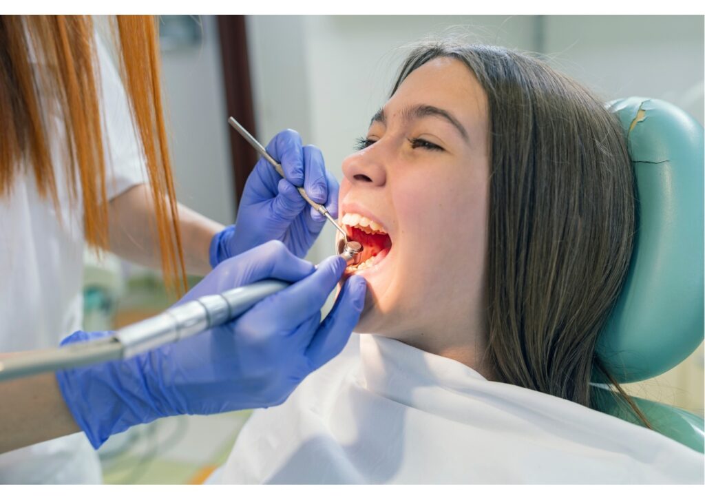 Dentist examining a patient’s teeth for signs of tooth decay and cavities during a dental checkup