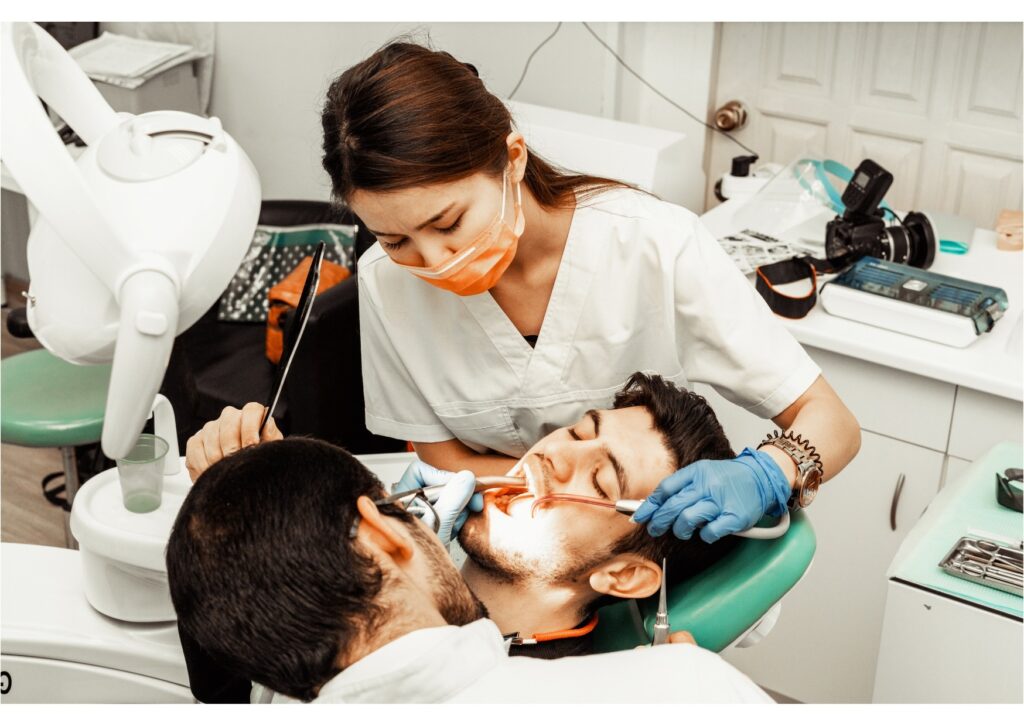 Emergency dental team treating a patient after a dental accident involving a swallowed tooth