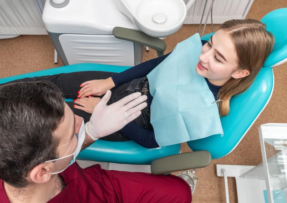 Dentist discussing dental retainer costs and treatment options with a patient during an appointment.